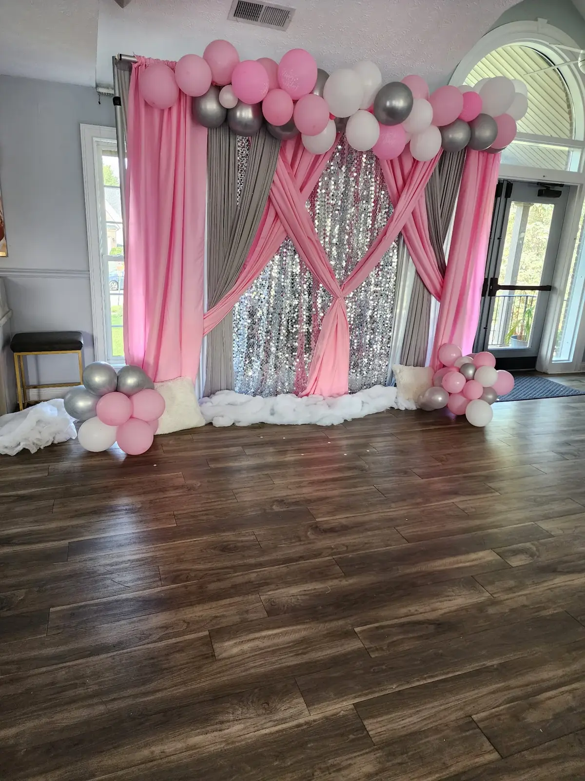Blush pink balloon arch and silver shimmer backdrop