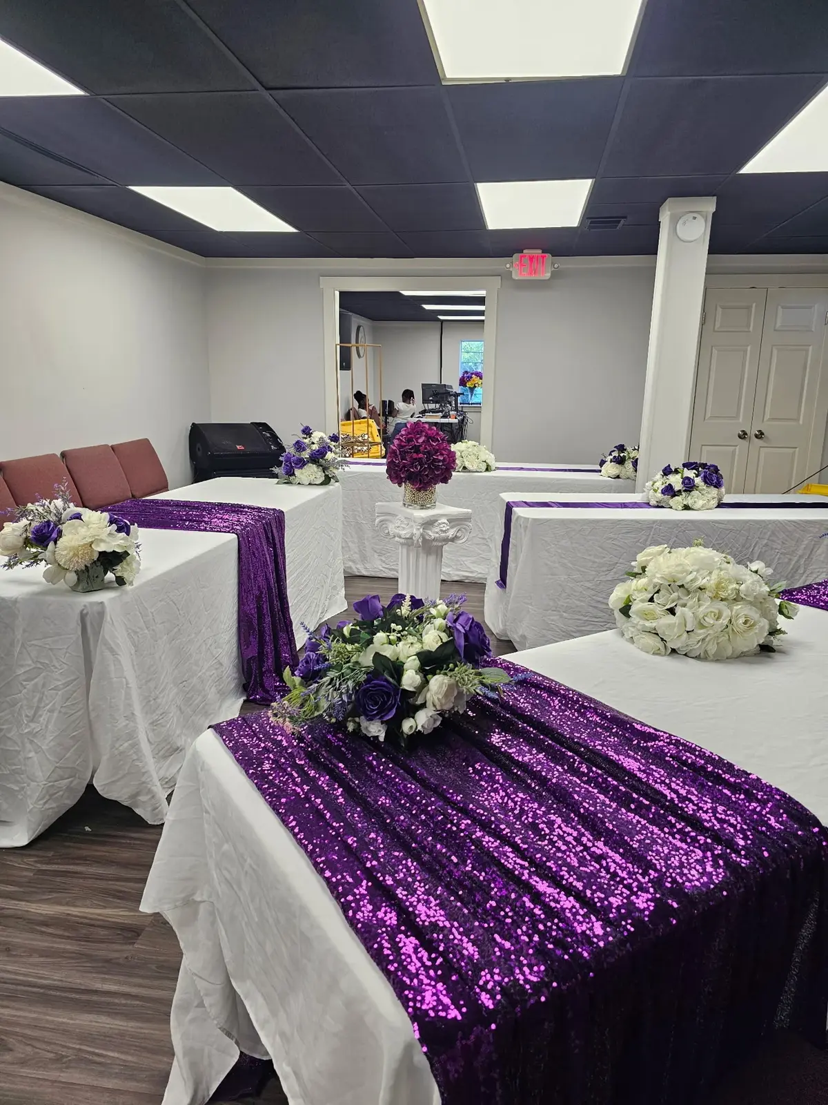 White and purple reception tables with matching floral centerpieces