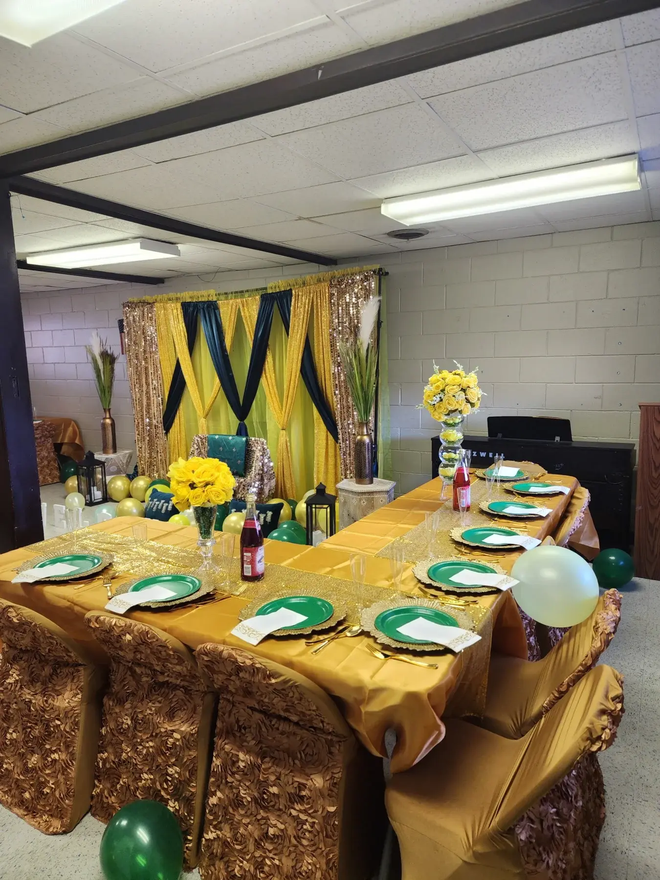 Gold celebration tables with blue and gold draping